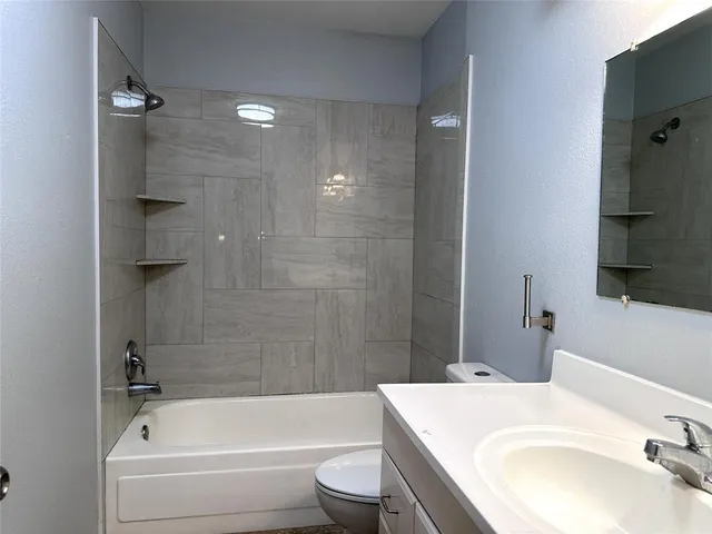 a bathroom with a sink a toilet and bathtub
