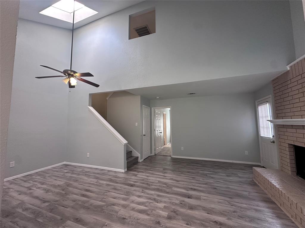 116 Main Place Euless, TX 76040 - Photo 4 of 31 a view of a room with wooden floor and a ceiling fan