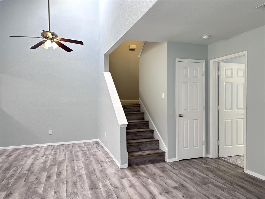 116 Main Place Euless, TX 76040 - Photo 6 of 31 a view of a hallway with wooden floor and staircase