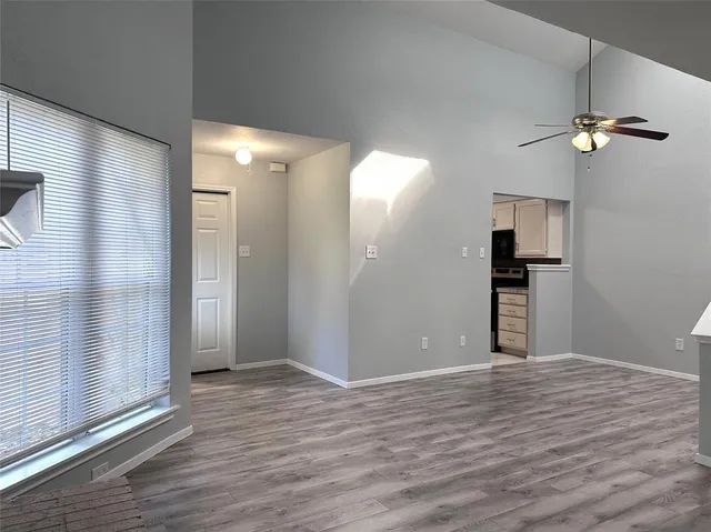 a view of empty room with wooden floor