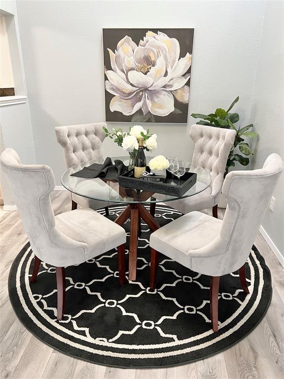 116 Main Place Euless, TX 76040 - Photo 8 of 31 a view of a dining room with furniture and wooden floor