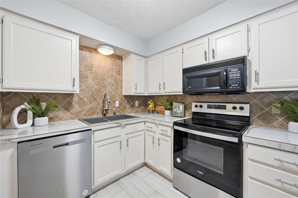 116 Main Place Euless, TX 76040 - Photo 10 of 31 a kitchen with a sink stove and microwave