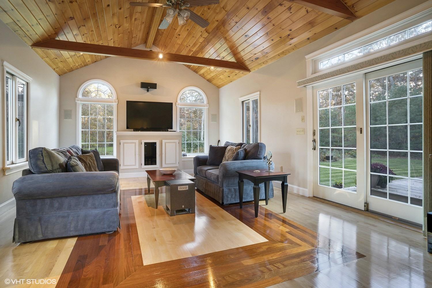 72 John Ewer Road Sandwich, MA 02563 - Photo 11 of 20 a living room with fireplace furniture and a flat screen tv