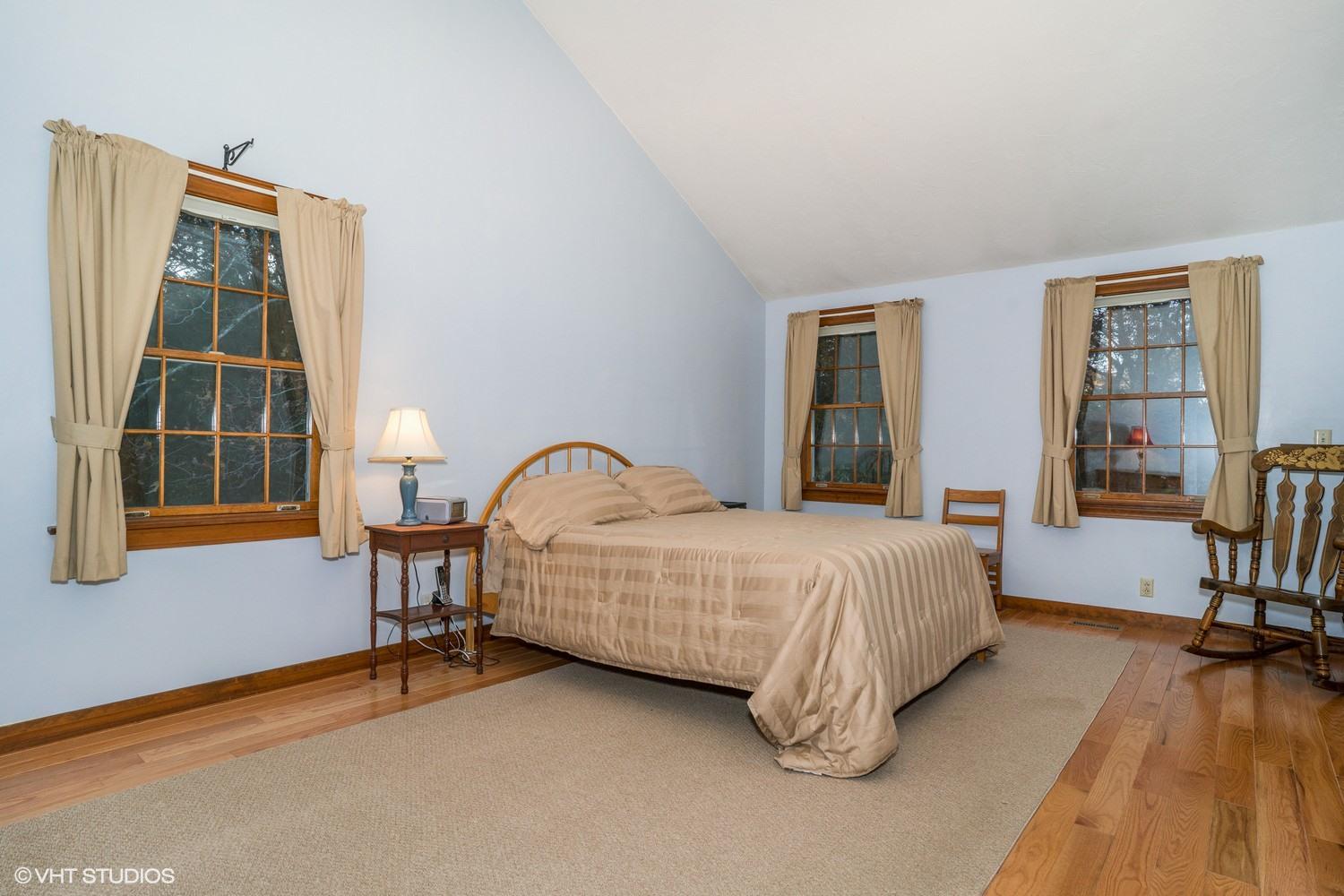 72 John Ewer Road Sandwich, MA 02563 - Photo 15 of 20 a spacious bedroom with a bed a table and windows