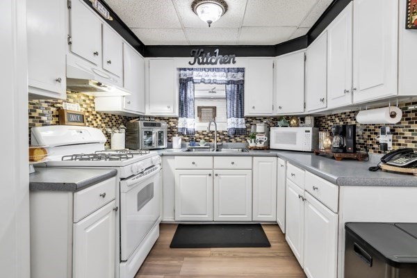 11 Cambridge Street Lawrence, MA 01843 - Photo 15 of 40 a kitchen with white cabinets and white appliances