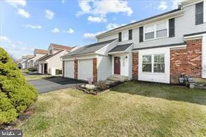 a front view of a house with a garden and yard