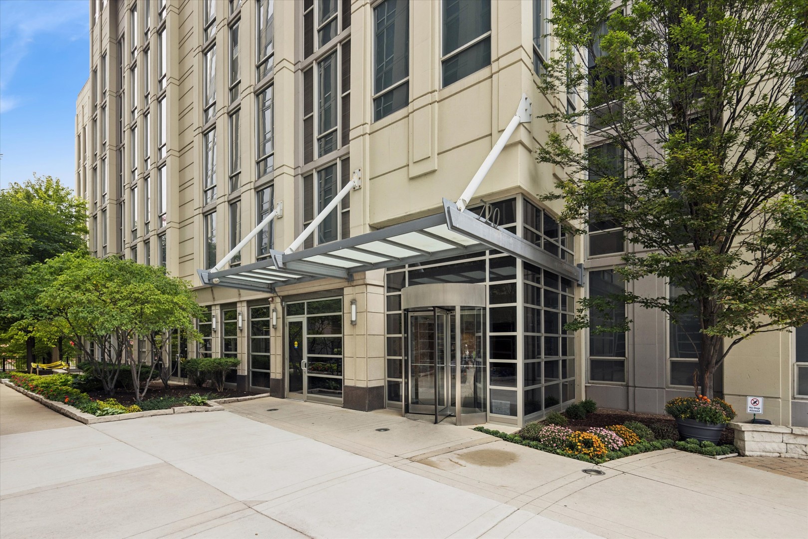 720 North Larrabee Street, Unit 1002 Chicago, IL 60654 - Photo 2 of 20 a front view of a building with a garden and parking space