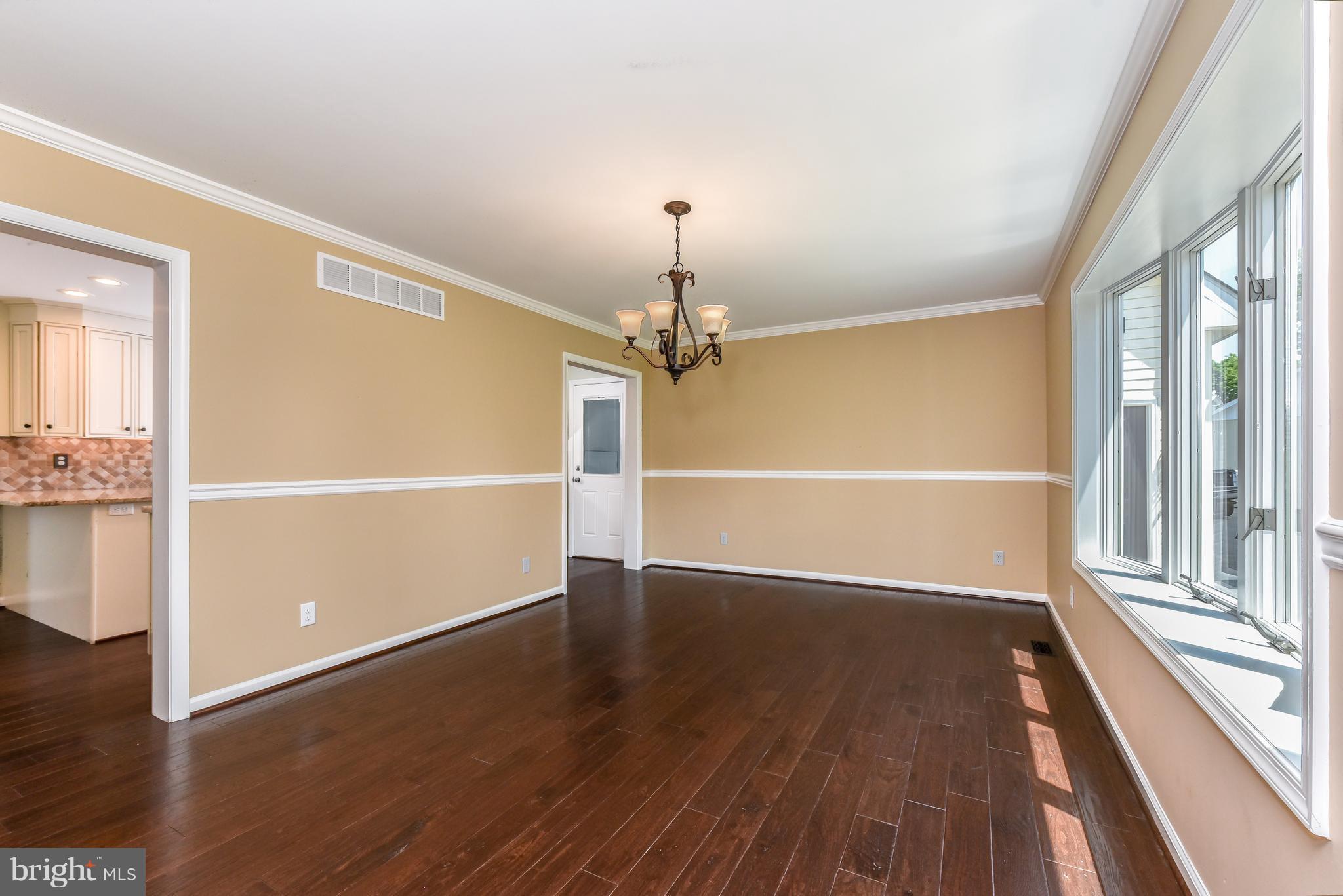 1101 Lombard Road Rising Sun, MD 21911 - Photo 3 of 26 an empty room with wooden floor fan and windows