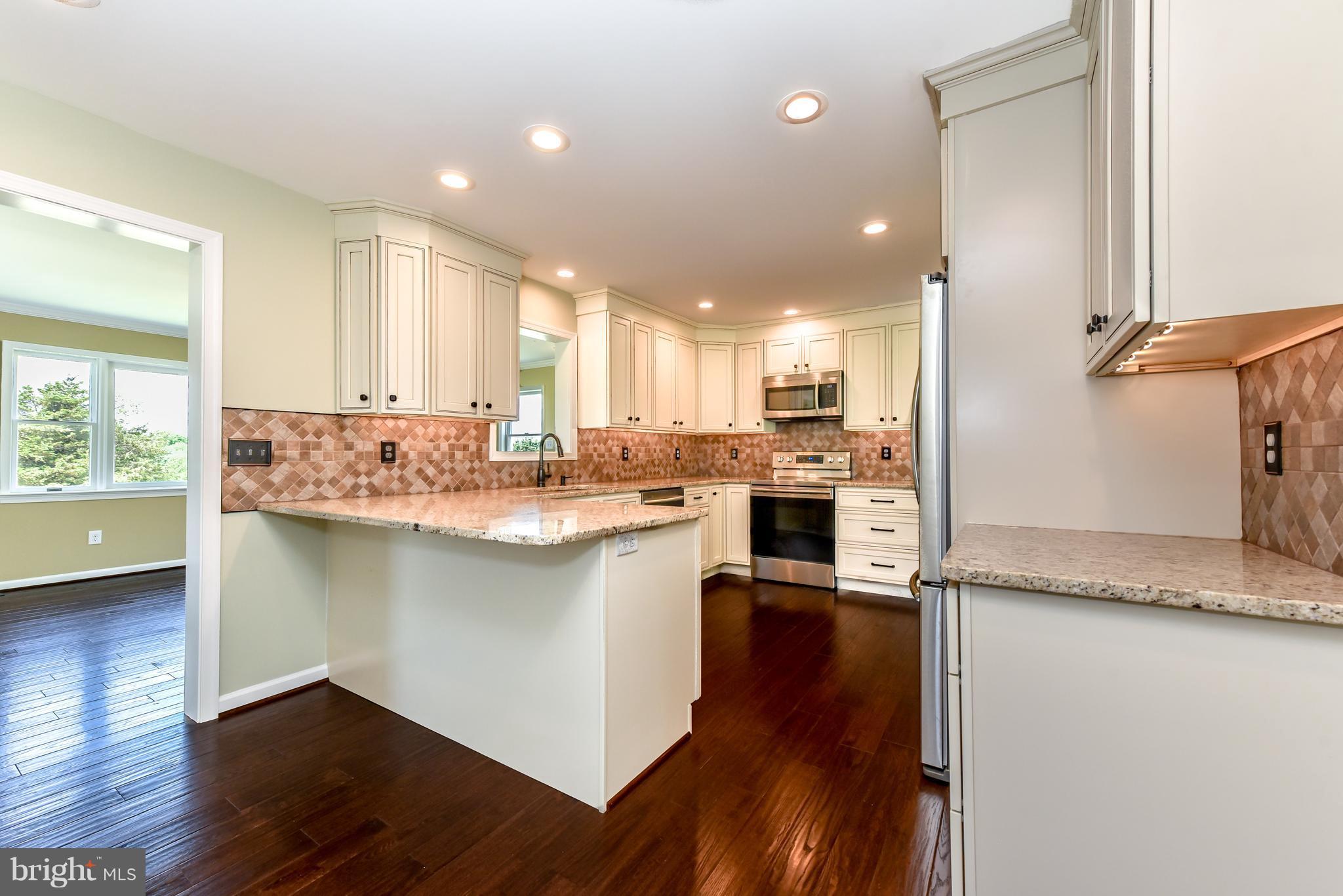 1101 Lombard Road Rising Sun, MD 21911 - Photo 8 of 26 a kitchen with a refrigerator sink and cabinets