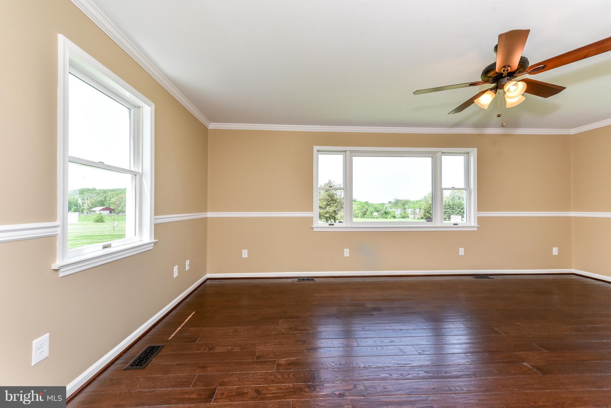 1101 Lombard Road Rising Sun, MD 21911 - Photo 9 of 26 an empty room with wooden floor and windows