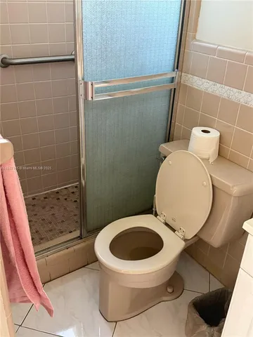 a white toilet sitting next to a bathroom sink