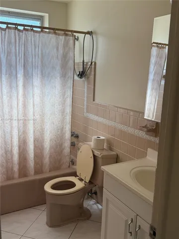 a bathroom with a toilet a sink and bathtub