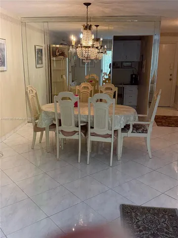 a dining room with furniture and chandelier