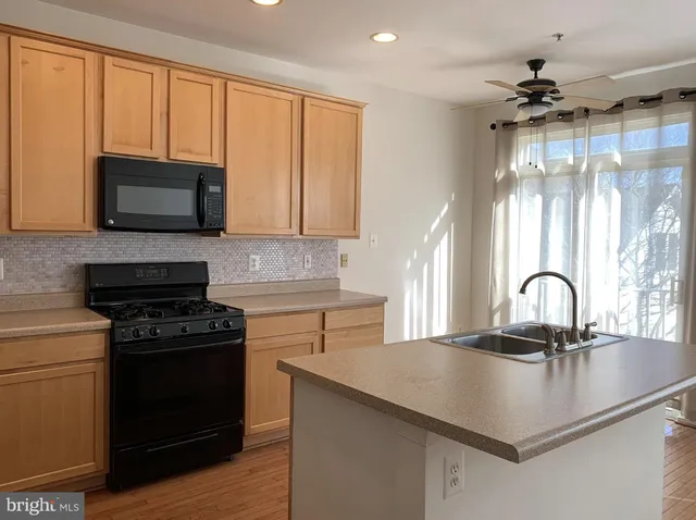 a kitchen with a stove a sink and a microwave