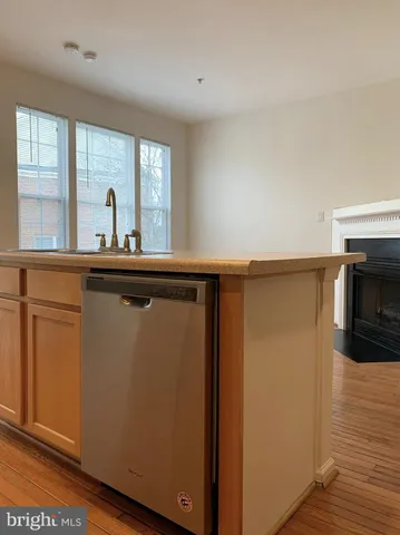 a view of a kitchen with wooden floor and a sink