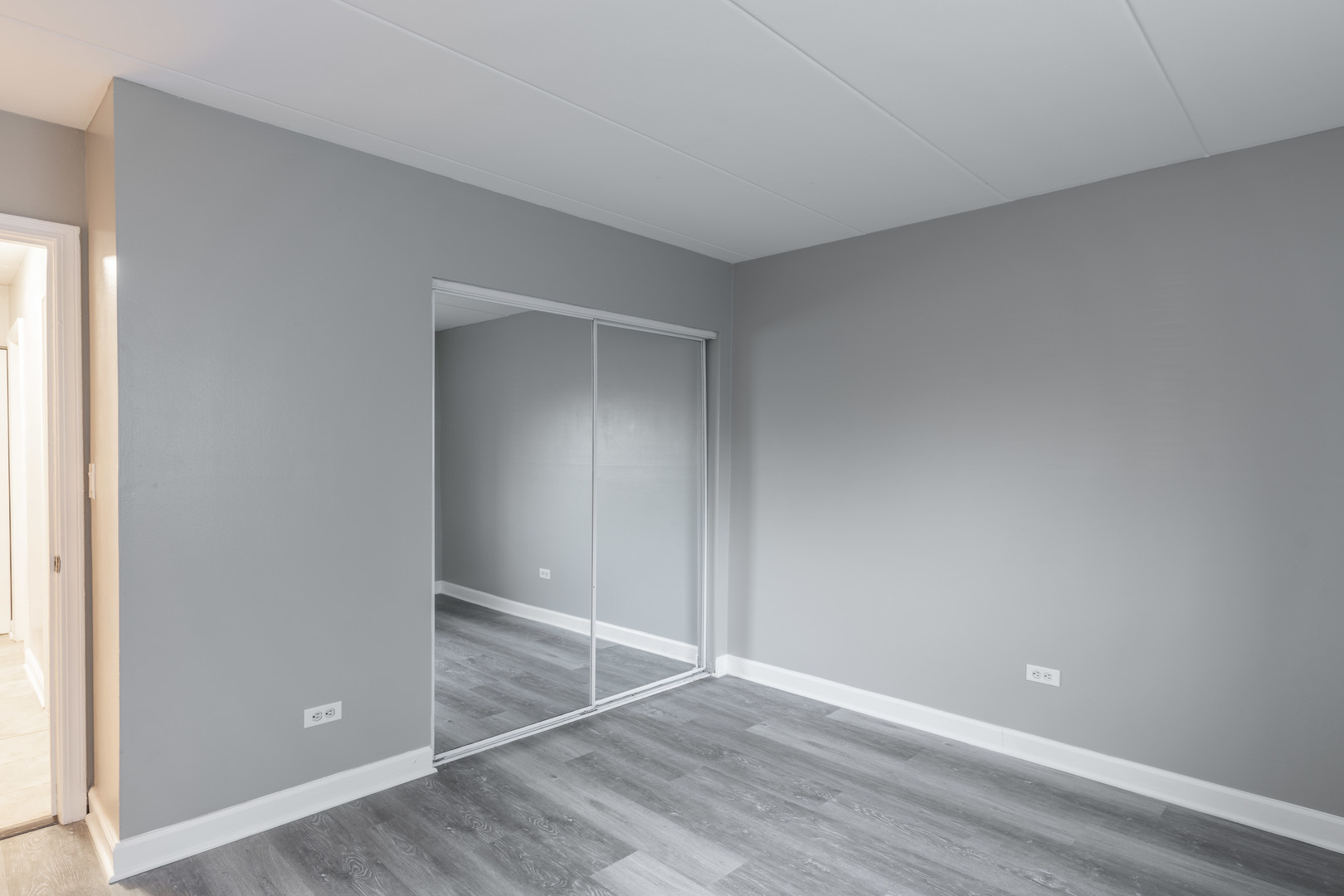 118 East Bailey Road, Unit A Naperville, IL 60565 - Photo 11 of 15 a view of an empty room with wooden floor and closet
