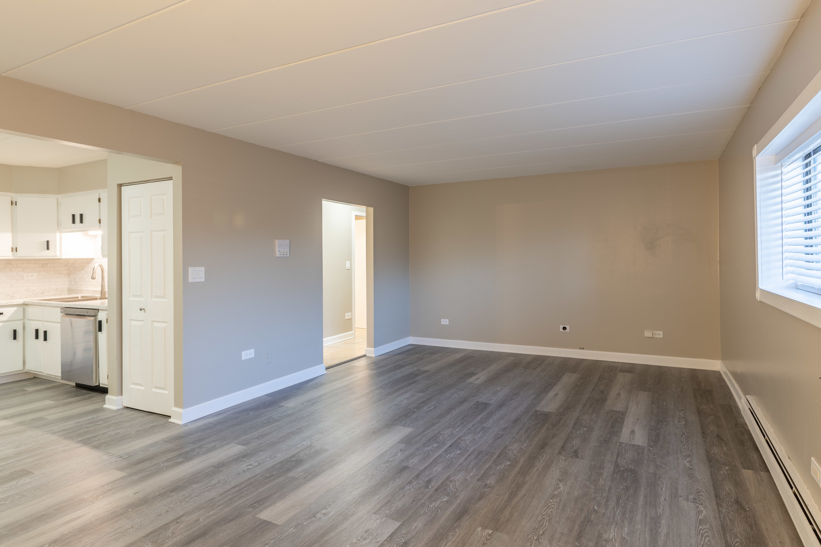 118 East Bailey Road, Unit A Naperville, IL 60565 - Photo 3 of 15 an empty room with wooden floor and windows