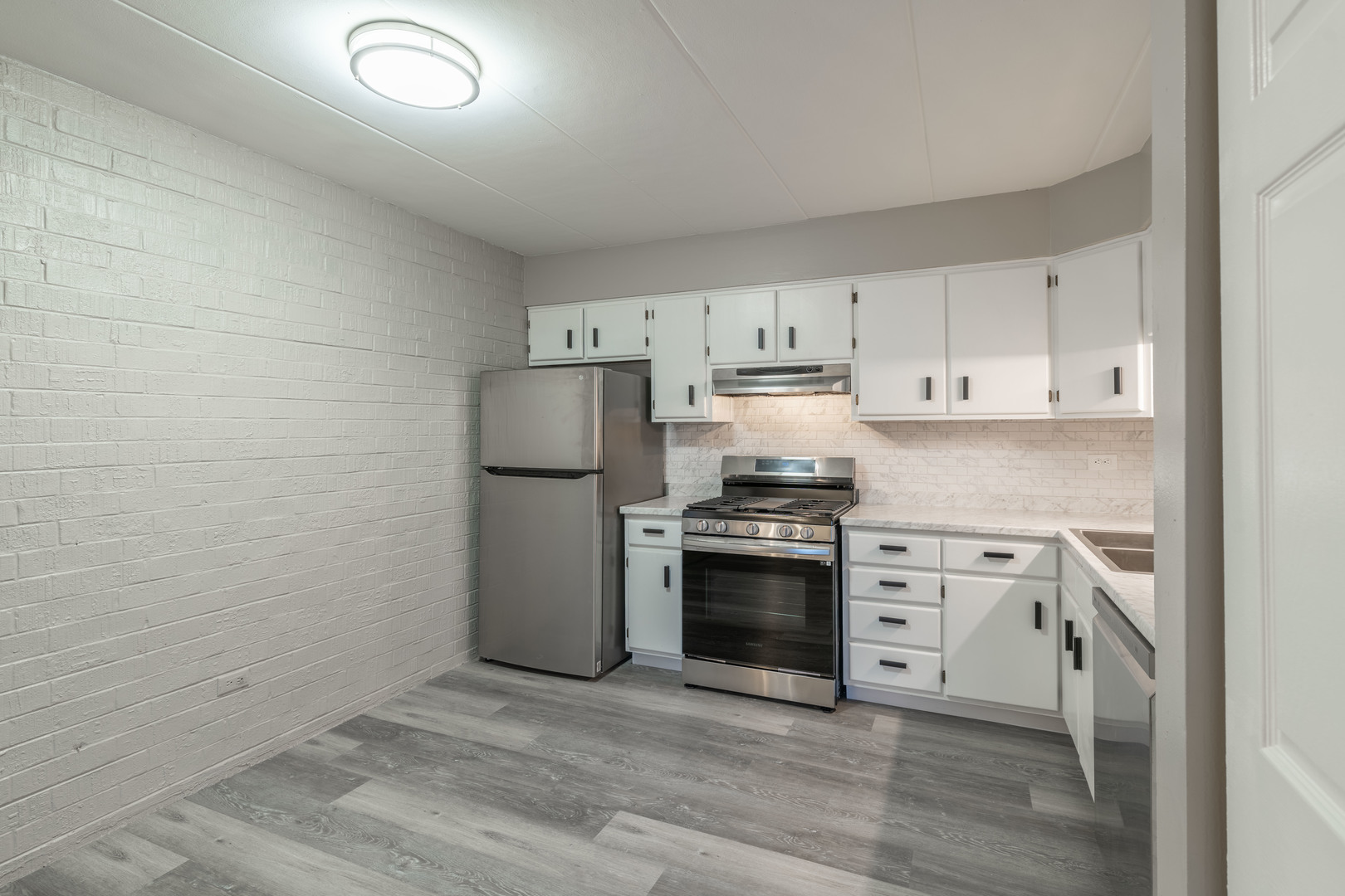 118 East Bailey Road, Unit A Naperville, IL 60565 - Photo 5 of 15 a kitchen with stainless steel appliances granite countertop a refrigerator stove and sink