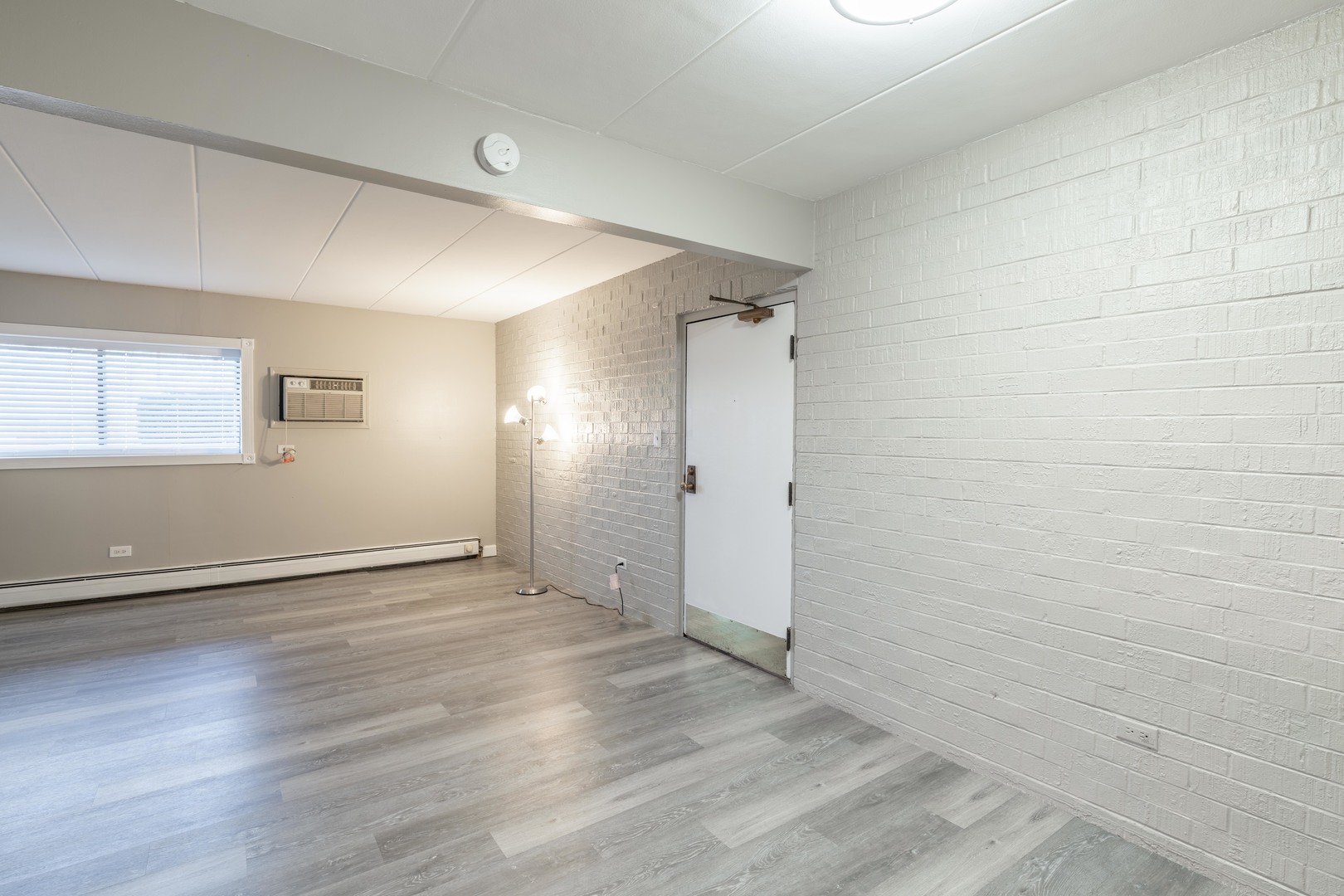 118 East Bailey Road, Unit A Naperville, IL 60565 - Photo 7 of 15 an empty room with wooden floor and windows