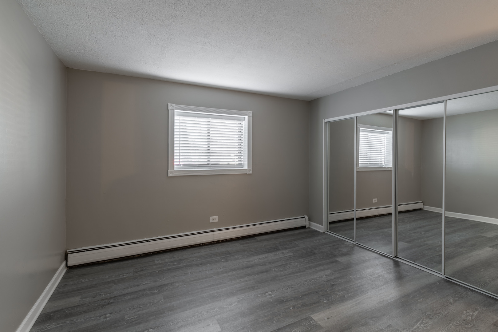 118 East Bailey Road, Unit A Naperville, IL 60565 - Photo 9 of 15 an empty room with wooden floor and windows