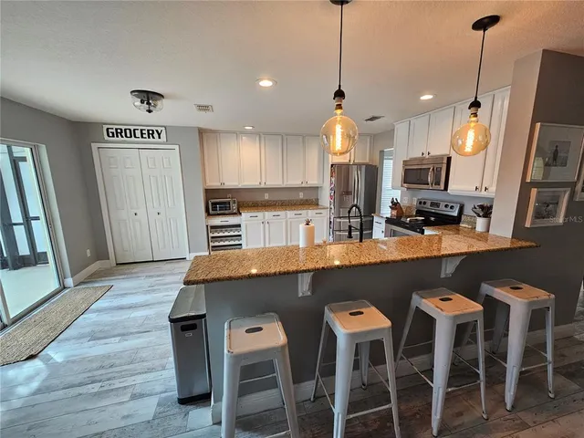 a large kitchen with a table and chairs