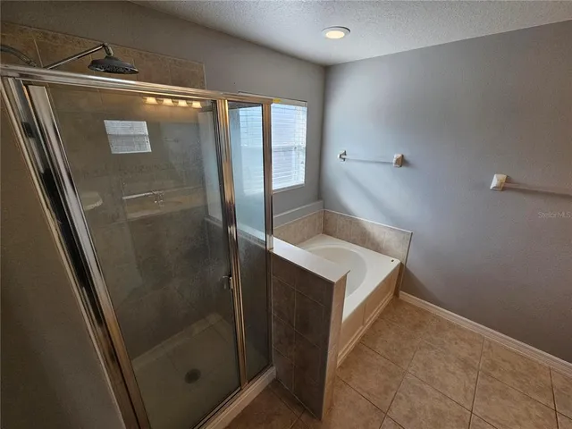 a bathroom with a shower and mirror