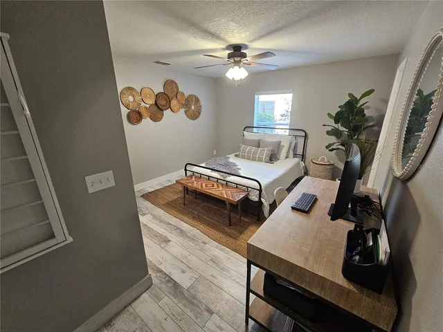 a bedroom with bed and a chandelier