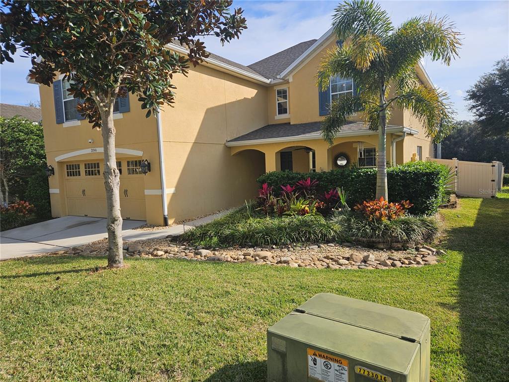 20946 Sullivan Ranch Boulevard Mount Dora, FL 32757 - Photo 2 of 26 a front view of a house with a garden
