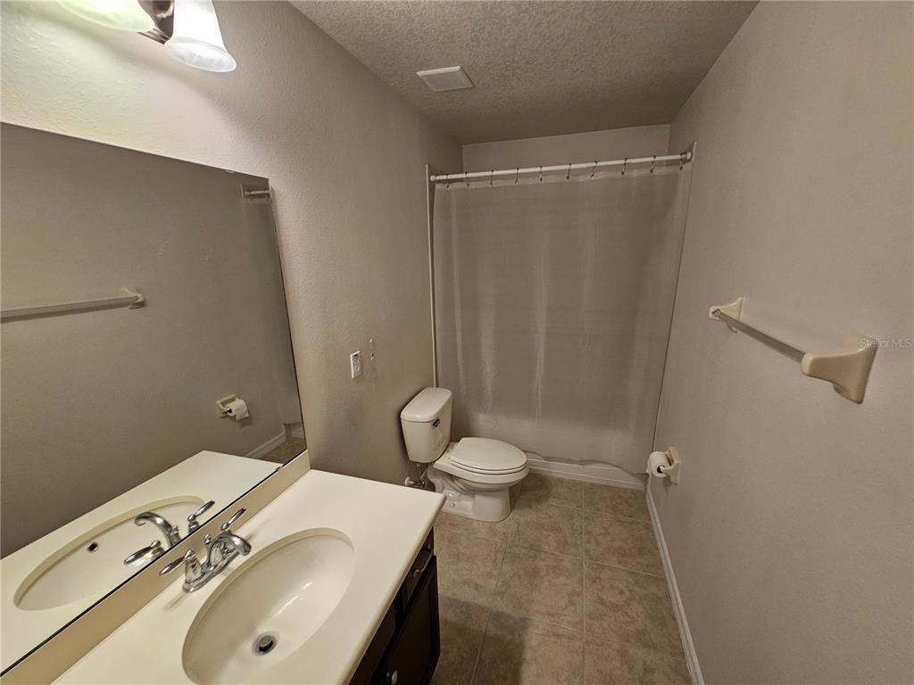 20946 Sullivan Ranch Boulevard Mount Dora, FL 32757 - Photo 21 of 26 a bathroom with a sink toilet and shower