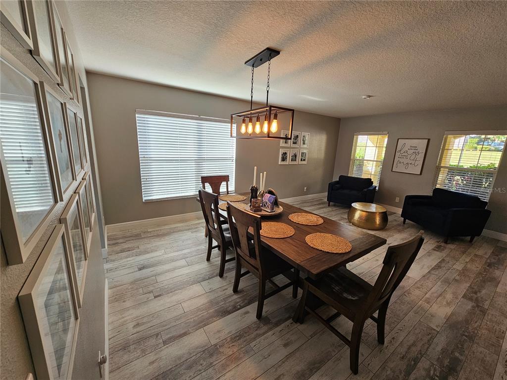 20946 Sullivan Ranch Boulevard Mount Dora, FL 32757 - Photo 7 of 26 a view of a dining room with furniture and window