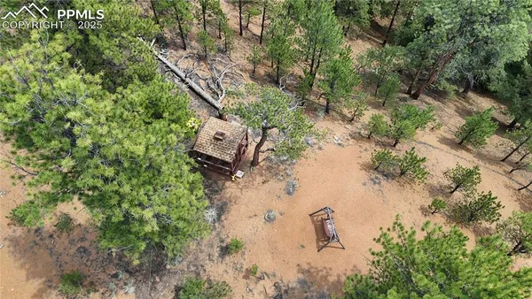 an aerial view of a house with a yard
