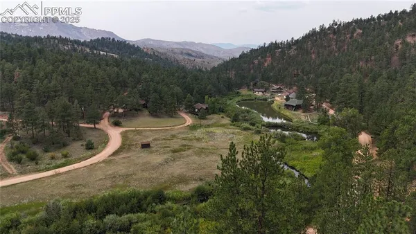 an aerial view of a house with a yard