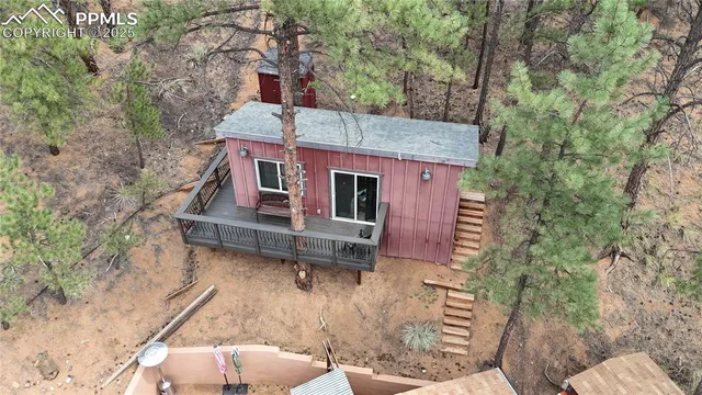 a front view of a house with a yard and potted plants