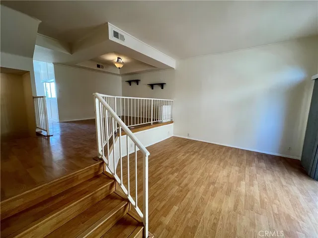 a view of entryway and hall with wooden floor