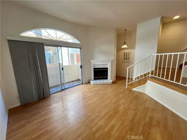 wooden floor in an empty room with a fireplace