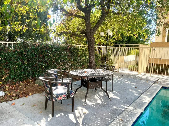 a view of a backyard with table and chairs