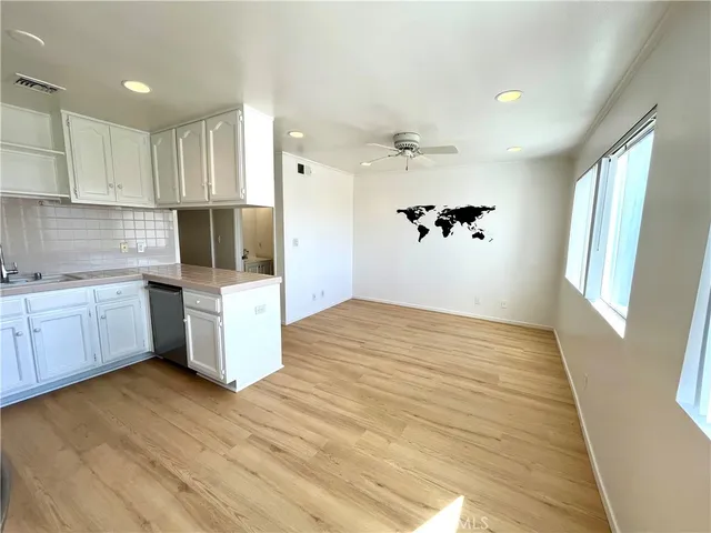 a view of a kitchen with wooden floor