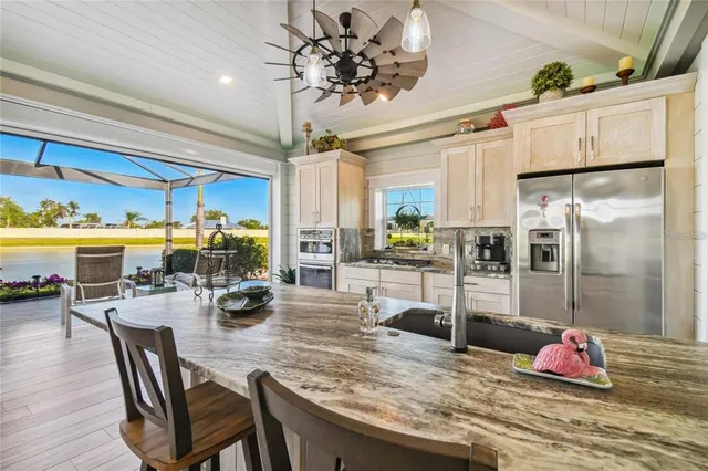 a kitchen with stainless steel appliances granite countertop a stove refrigerator and microwave