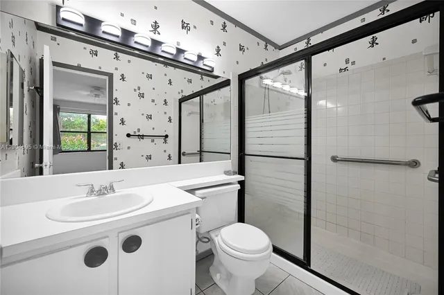 an empty room with closet and windows