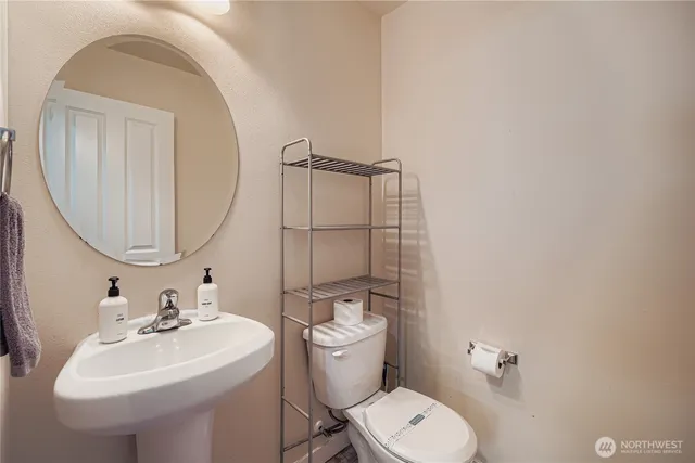 a bathroom with a sink a toilet and a mirror