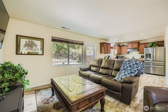 a living room with furniture and a potted plant