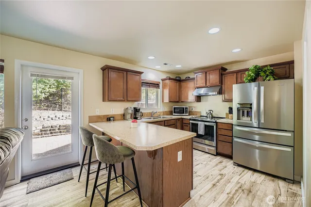 a kitchen with granite countertop a stove and a refrigerator
