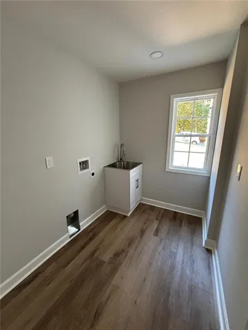 a view of a hallway with windows and chandelier
