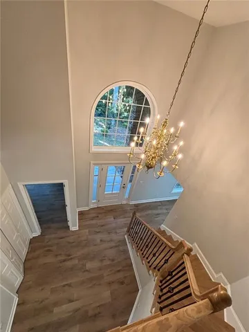 a view of a bedroom with wooden floor