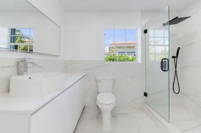 a bathroom with a toilet sink and shower