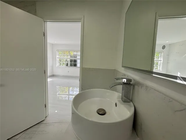 a bathroom with a sink and mirror