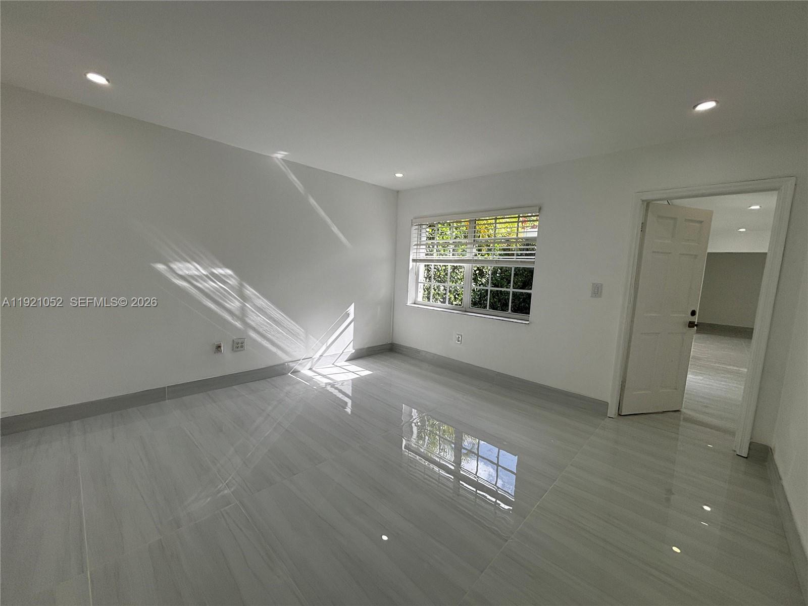 725 91st Street Surfside, FL 33154 - Photo 18 of 32 a view of an empty room with a window