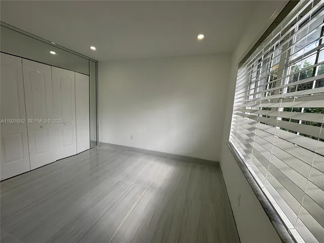 a view of an empty room and wooden floor