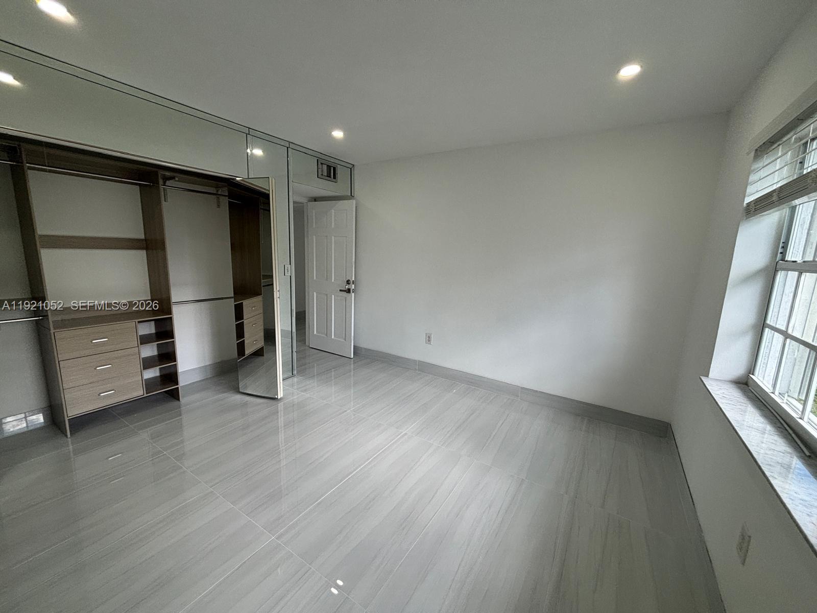 725 91st Street Surfside, FL 33154 - Photo 19 of 32 a view of an empty room with a window