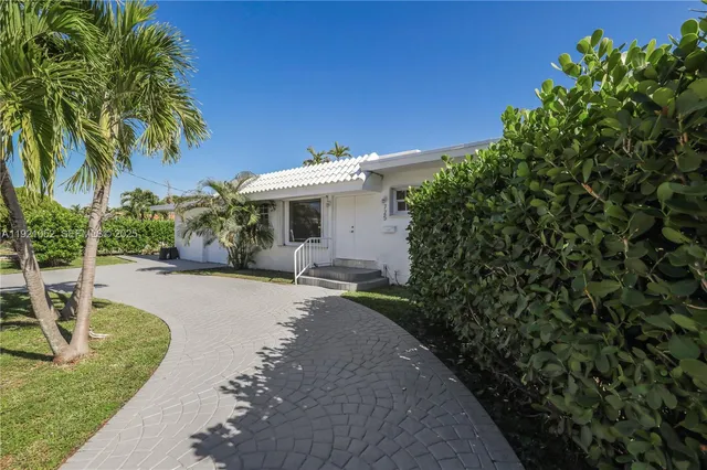 a front view of a house with a yard and a garage